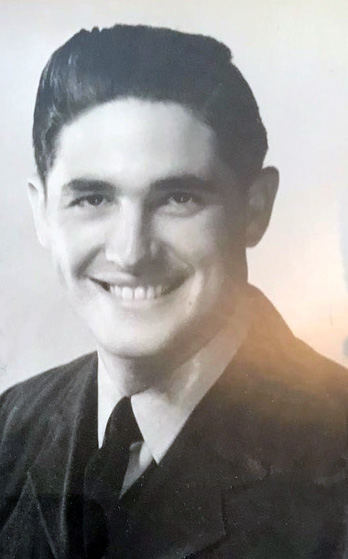 Black and white portrait of Eric smiling in uniform,